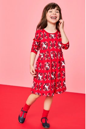 girl in long sleeve red unicorn dress