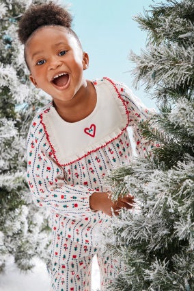 girl in holiday flannel pajamas