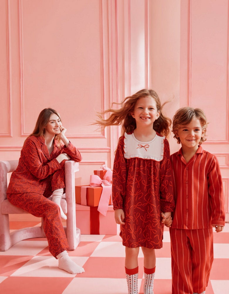 family in matching red holiday print pajamas