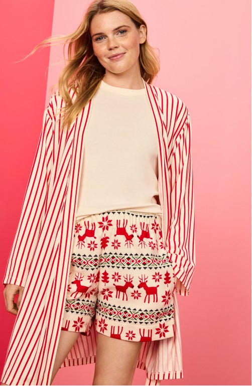woman in holiday pajamas and robe