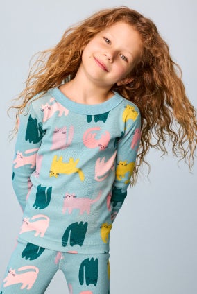 girl in long sleeve cat printed pajamas
