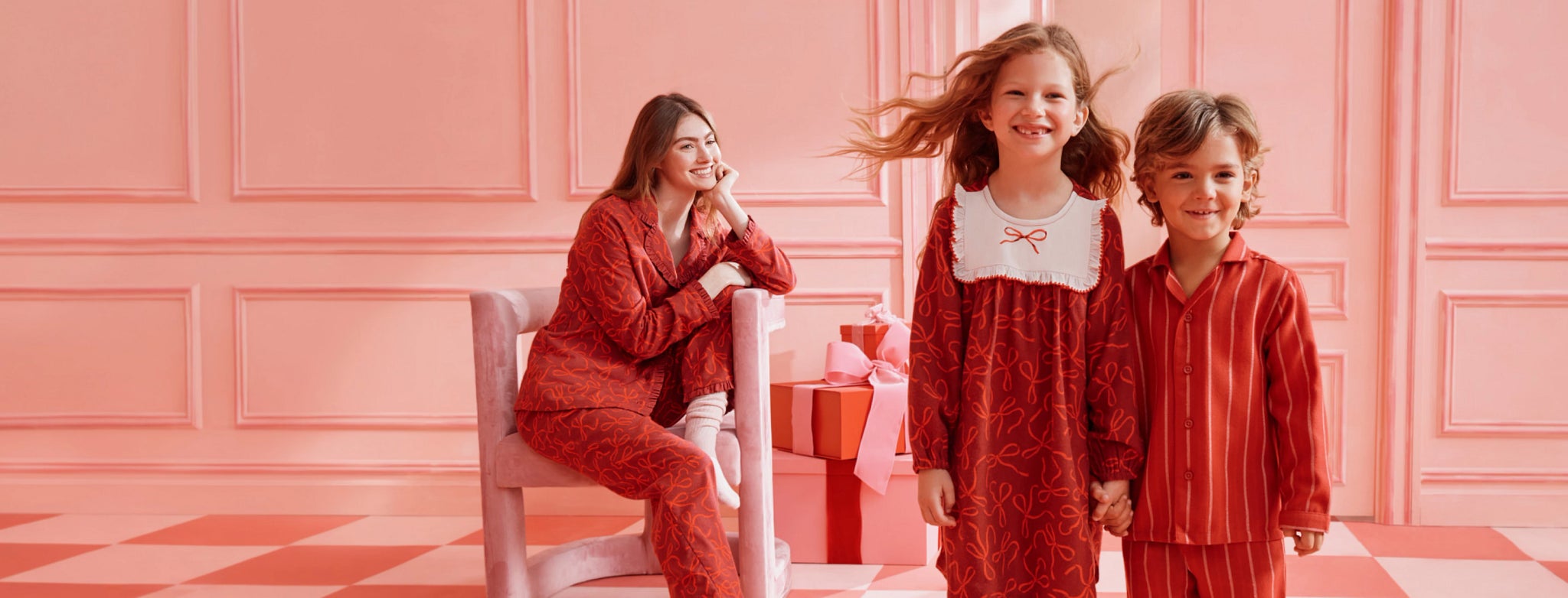 family in matching red holiday print pajamas