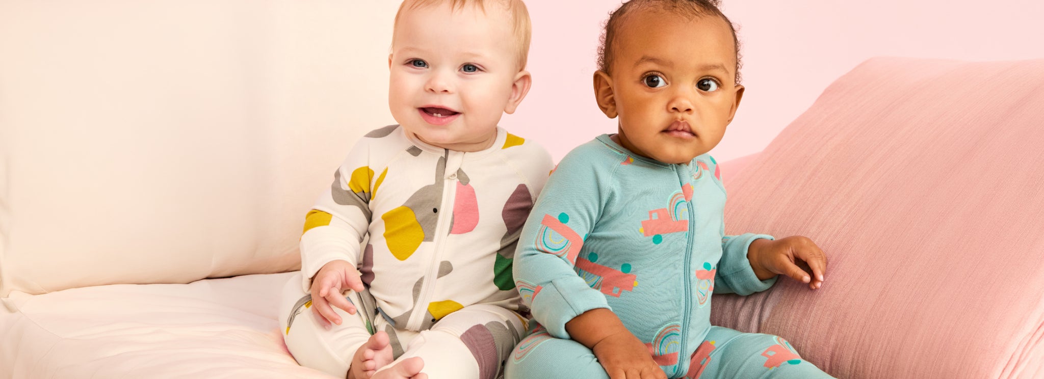 newborn baby sleepers two babies wearing printed baby sleepers