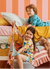 Two children wearing pajamas in bed